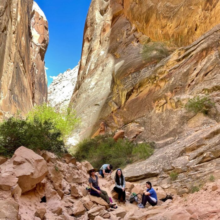 group of young people having lunch inside a canyon
