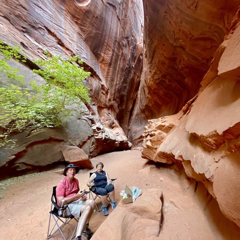 older couple having a picnic in a slot canyon, off the burr trail, grand staircase-esclante utah