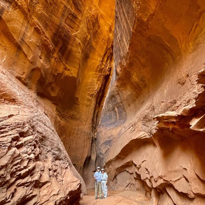 older couple inside a slot canyon in grand staircase-esclante national monument, comma