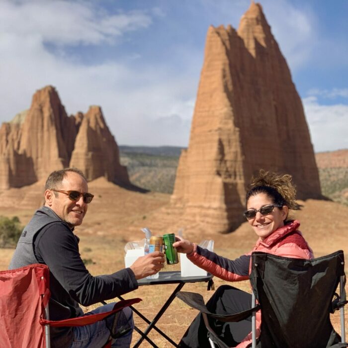 couple having picnic in front of the cathedral mountains